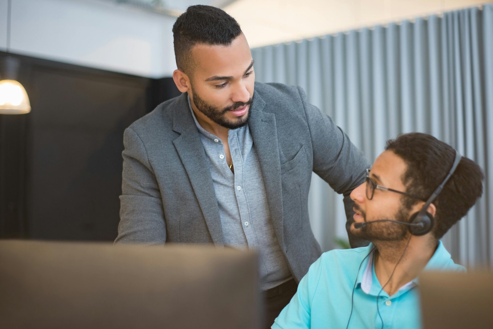 Two men collaborating in an office environment, fostering teamwork.